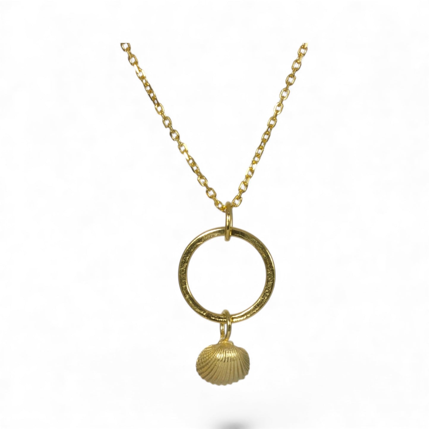 Gold necklace with a circular pendant and shell charm on a white background