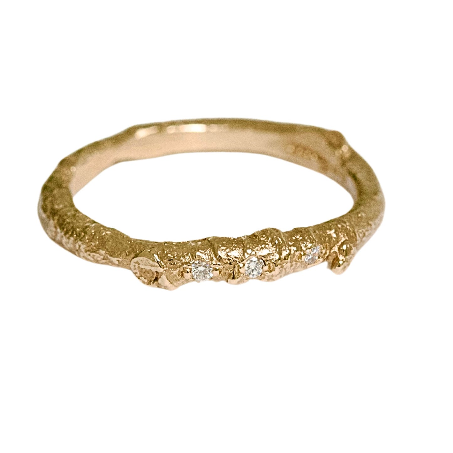 A nature twig wedding ring cast from a real twig in 9ct gold and embedded with three white natural diamonds.