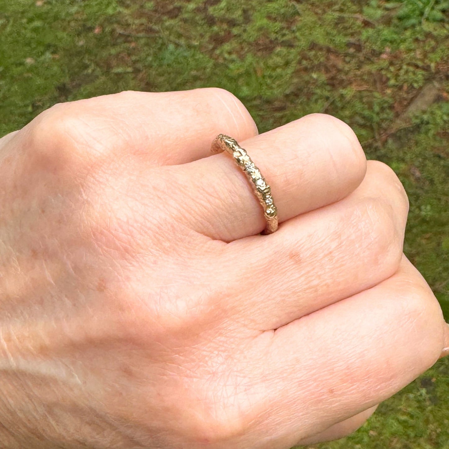 A nature twig wedding ring cast from a real twig in 9ct gold and embedded with three white natural diamonds.