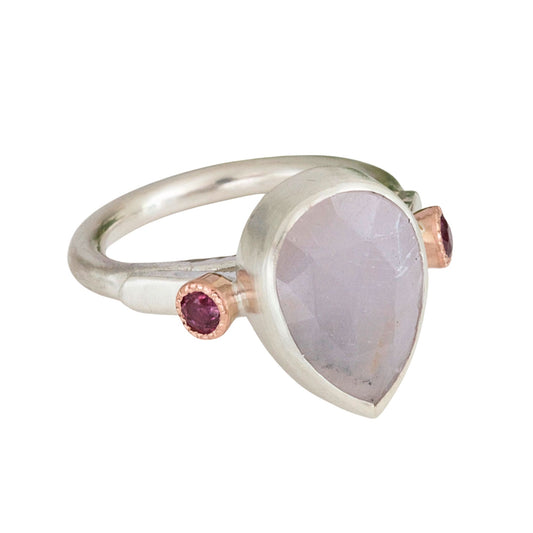 Handmade sculptural lilac sapphire ring handmade in satin finished silver with side rubies set in rose gold.