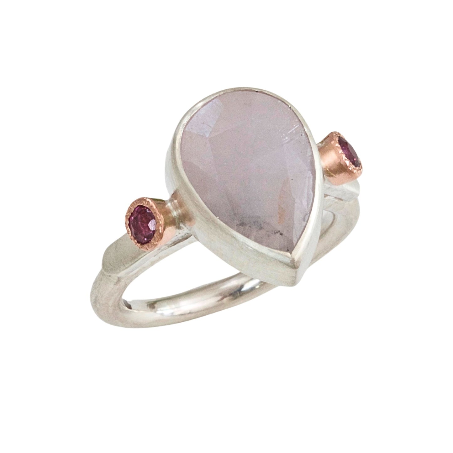Handmade sculptural lilac sapphire ring handmade in satin finished silver with side rubies set in rose gold.
