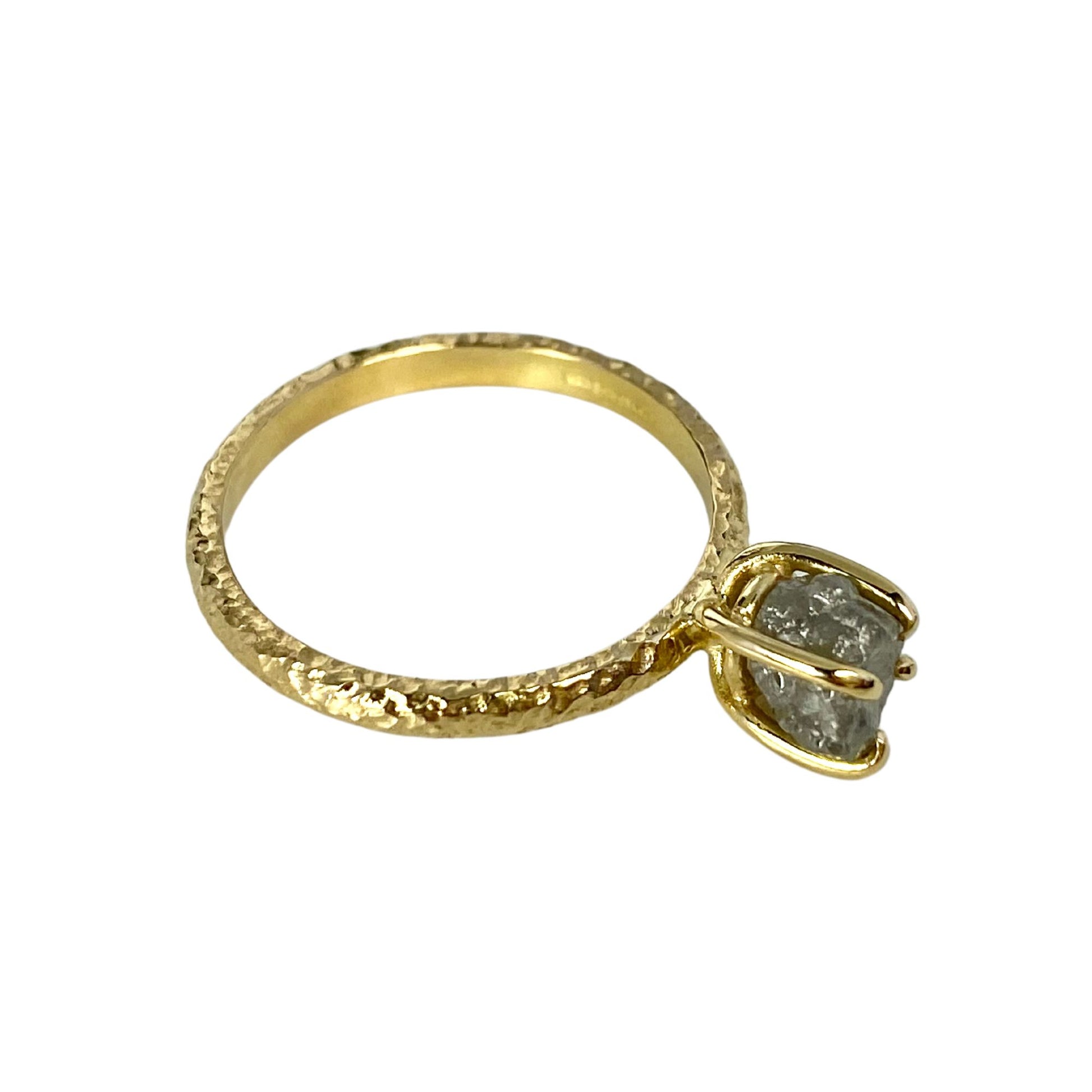 textured 18ct gold engagement ring with a claw set natural rough uncut diamond.