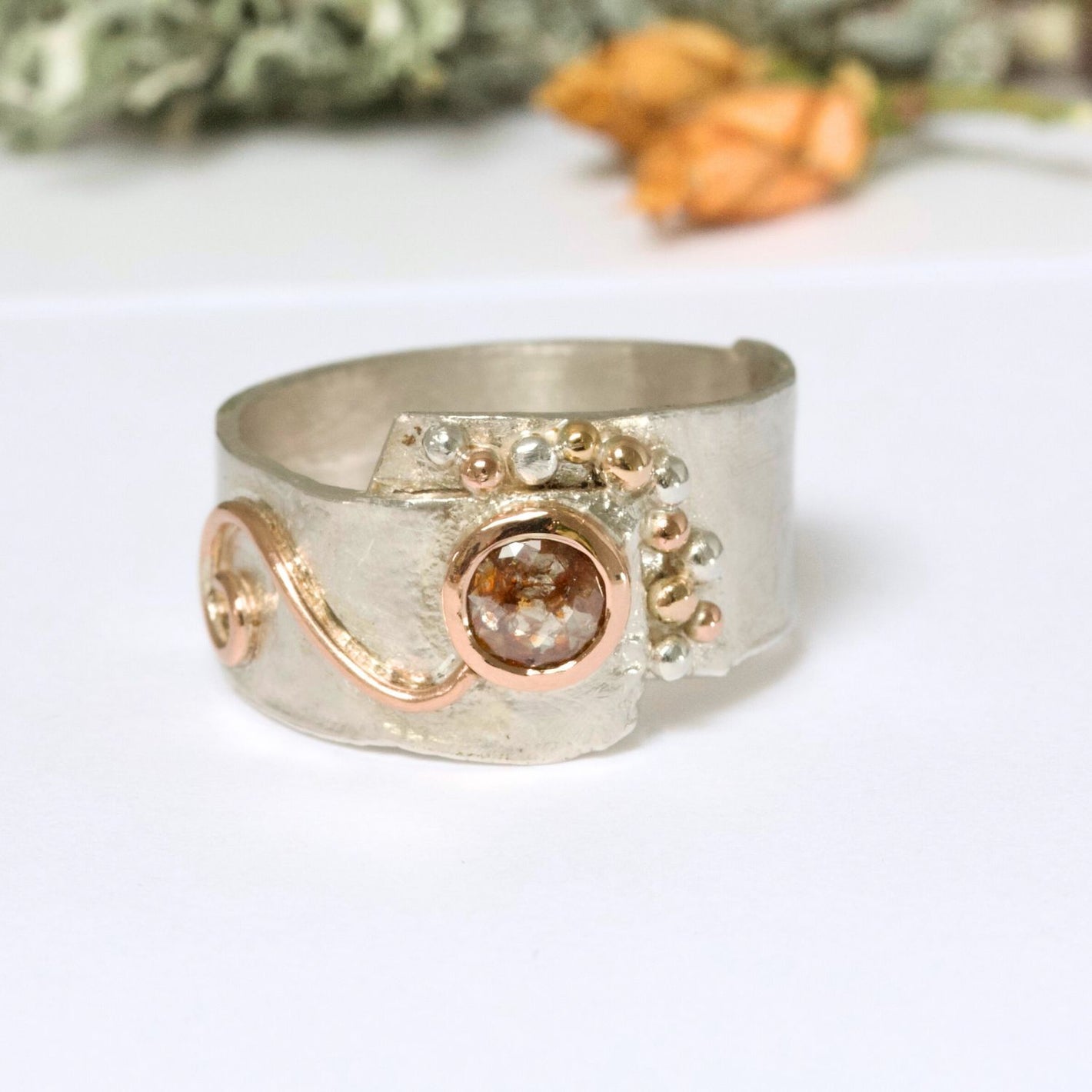 rose cut salt and pepper rustic diamond ring in a wide silver band with rose gold.