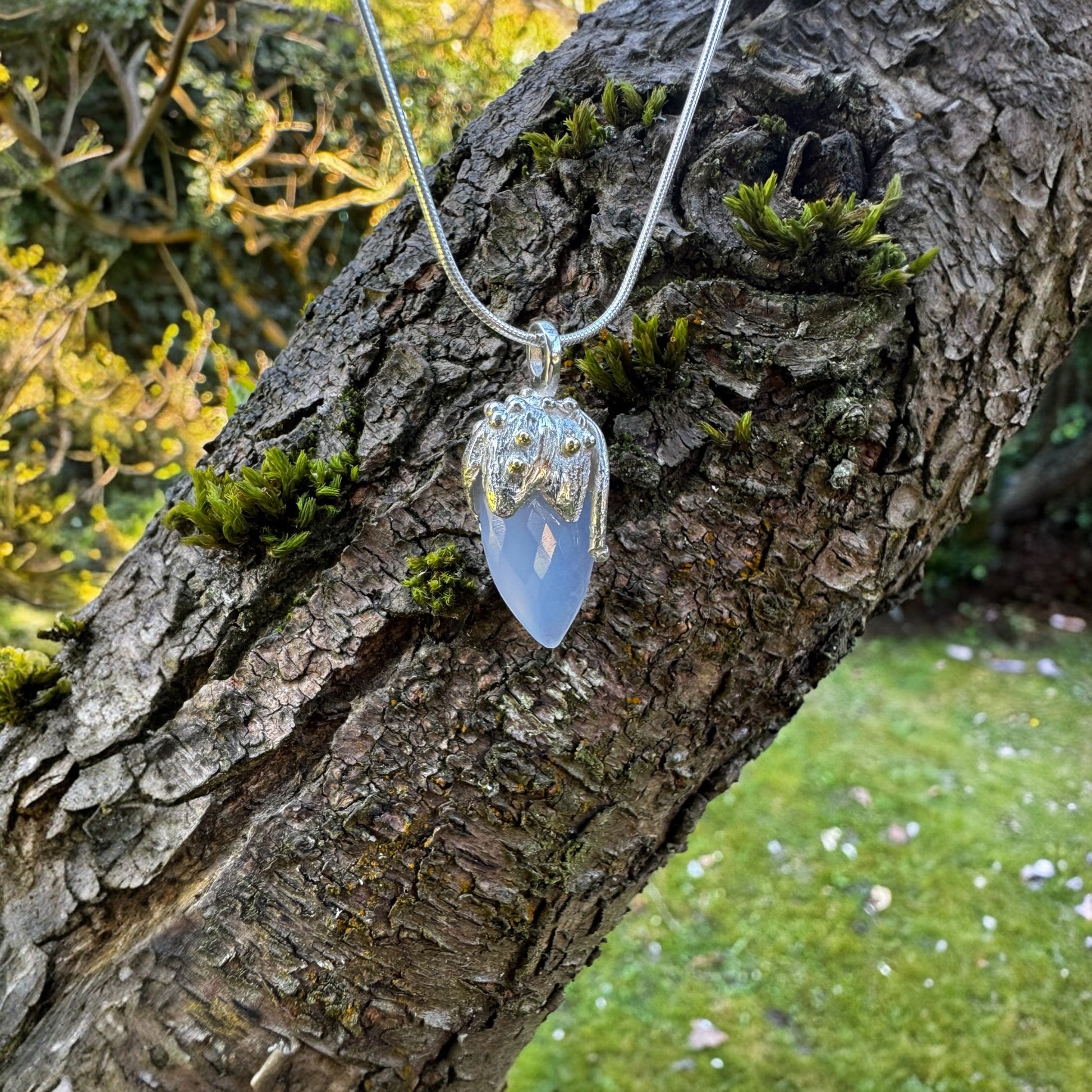 Briolet Chalcedony Amulet Pendant capped in sterling silver with 18 carat gold on a snake chain.