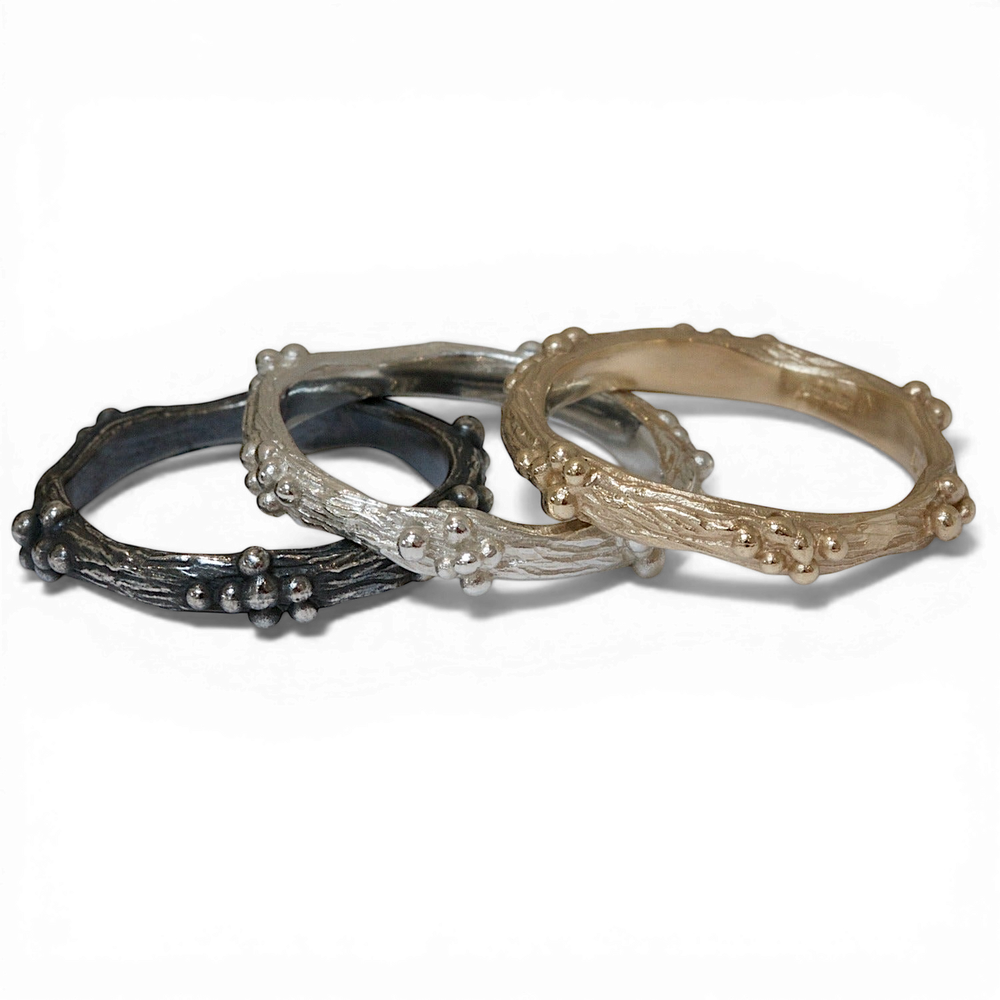 Silver and gold twig textured rings with granulation.