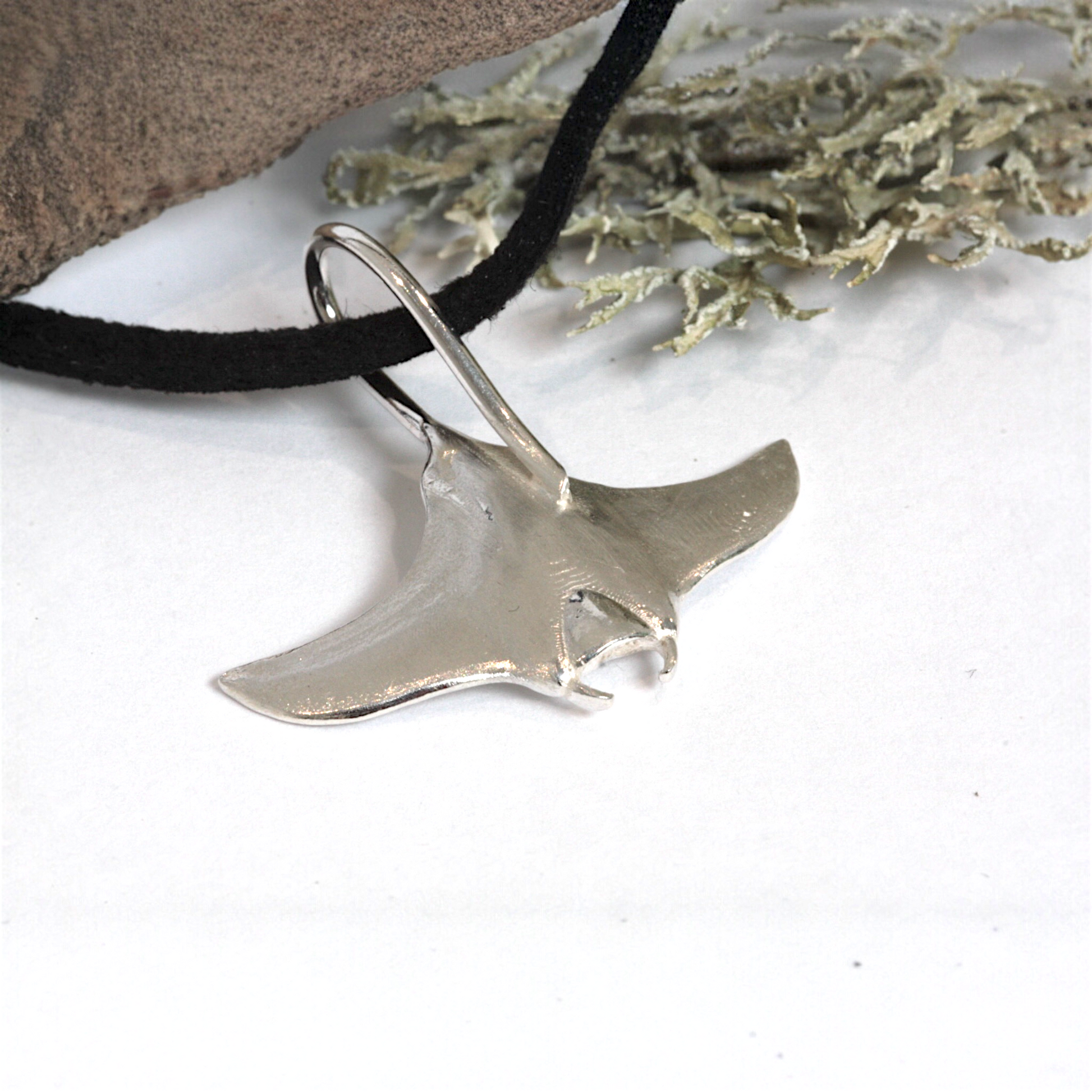 Solid sterling silver manta ray pendant on a faux suede thong necklace.