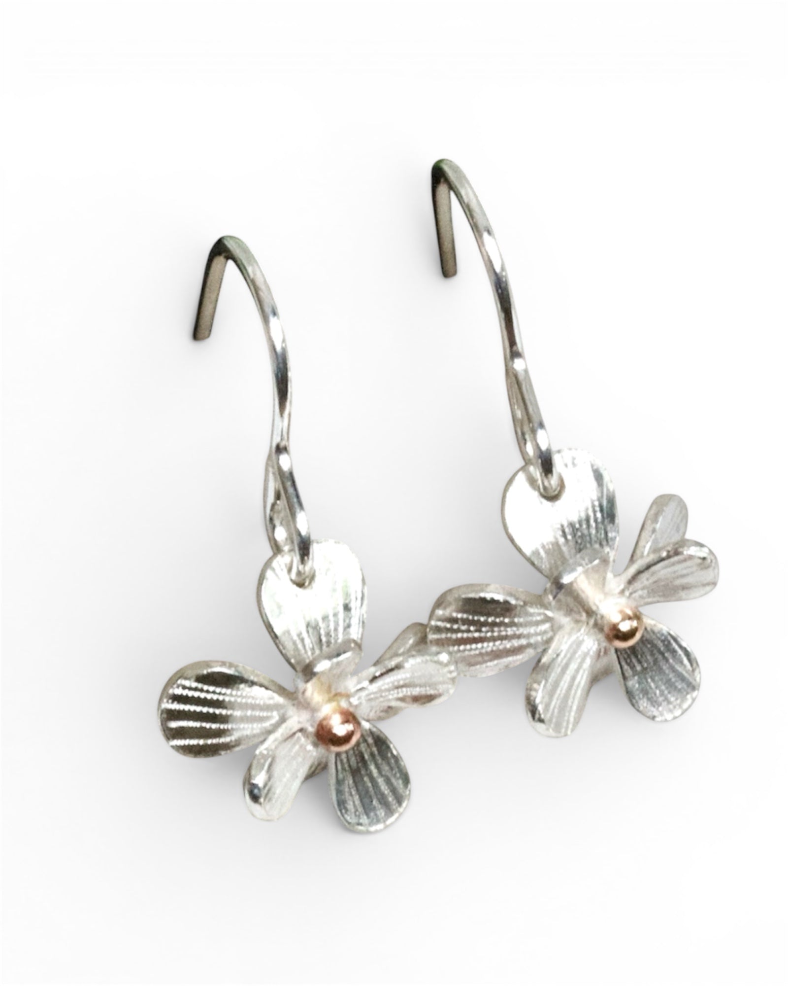 Silver flower-shaped earrings on a white background