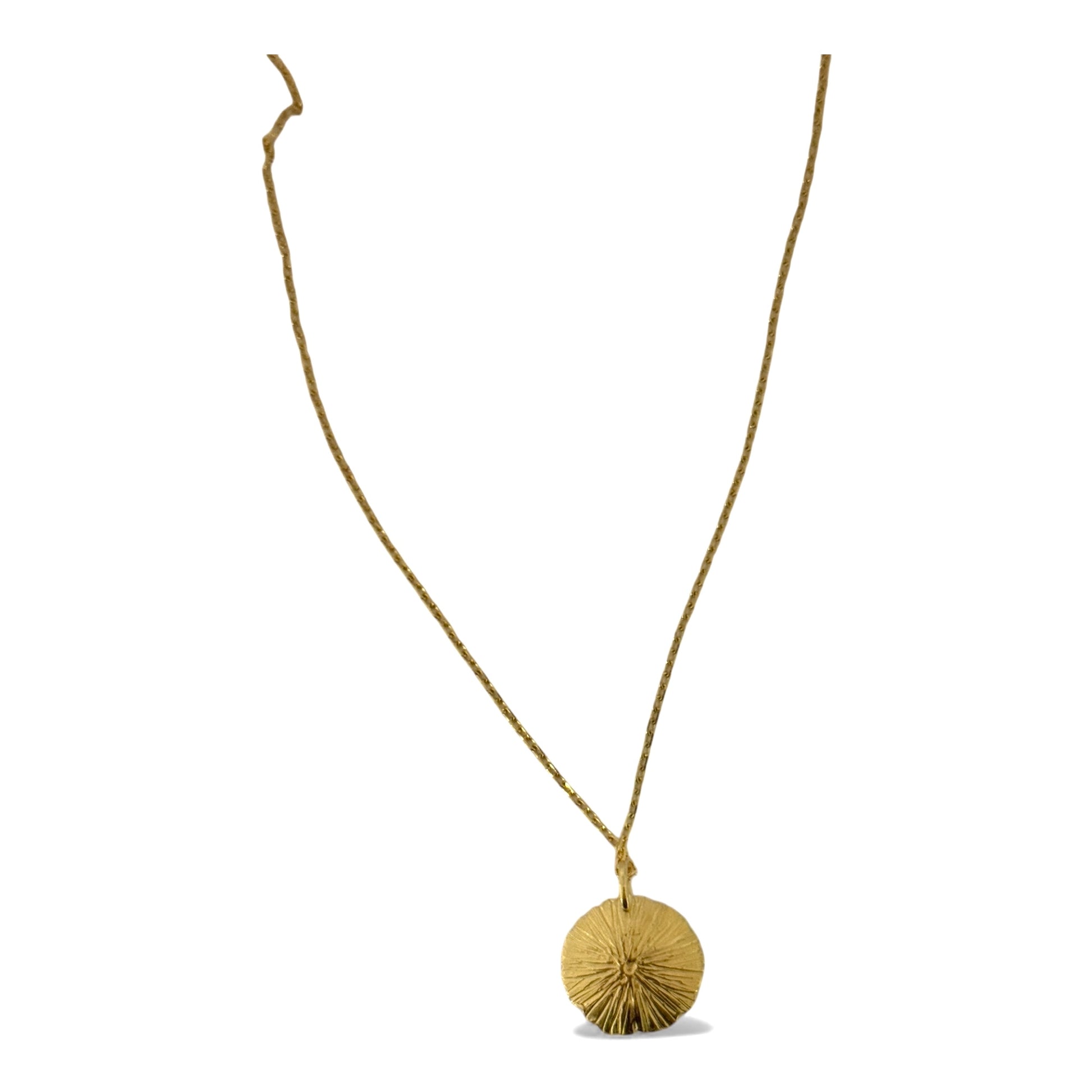 Gold necklace with a round textured sunshine pendant on a white background