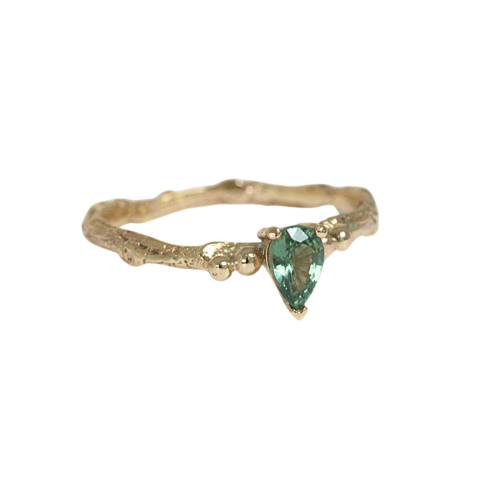 Pear shape green sapphire nature inspired twig engagement ring. Cast from a real twig in 9ct yellow gold and set with a teardrop green sapphire in a claw setting. Also can be ordered in white gold.