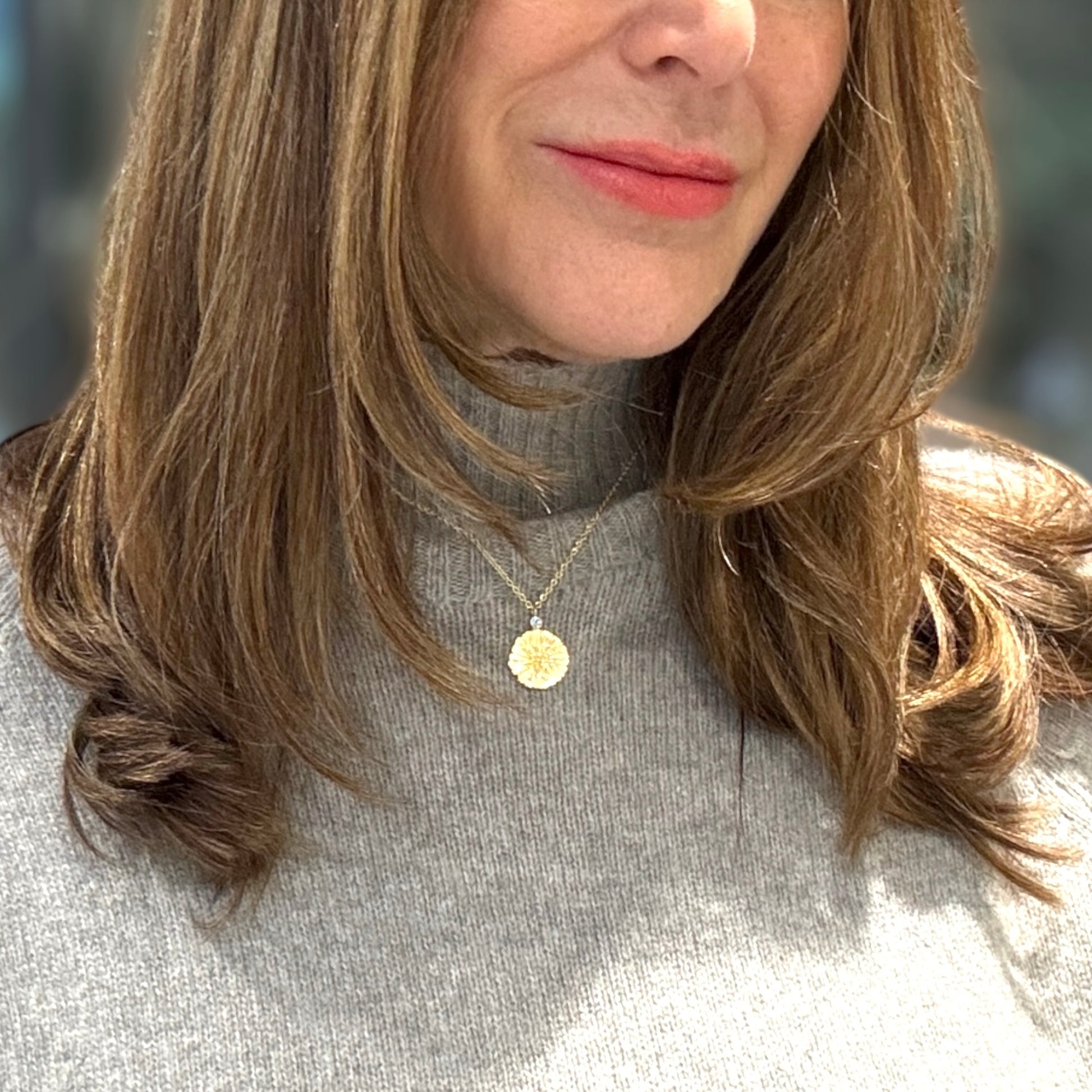 Sun pendant in gold vermeil with a blue topaz gemstone on a 16 inch chain.