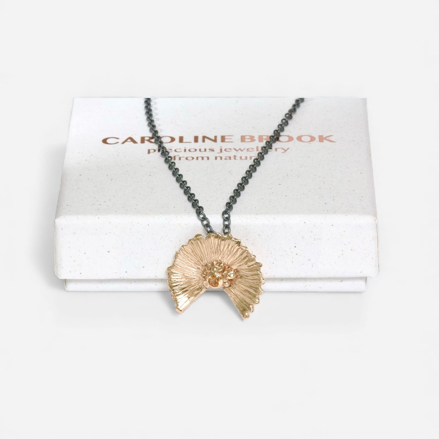 9ct Gold Sunset Necklace with orange Sapphire on an oxidised black silver chain.