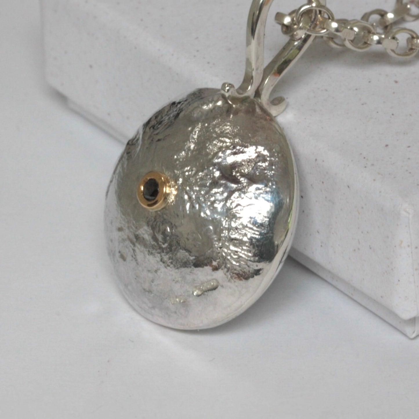 Reticulated silver necklace with salt and pepper diamond set in 18ct gold.