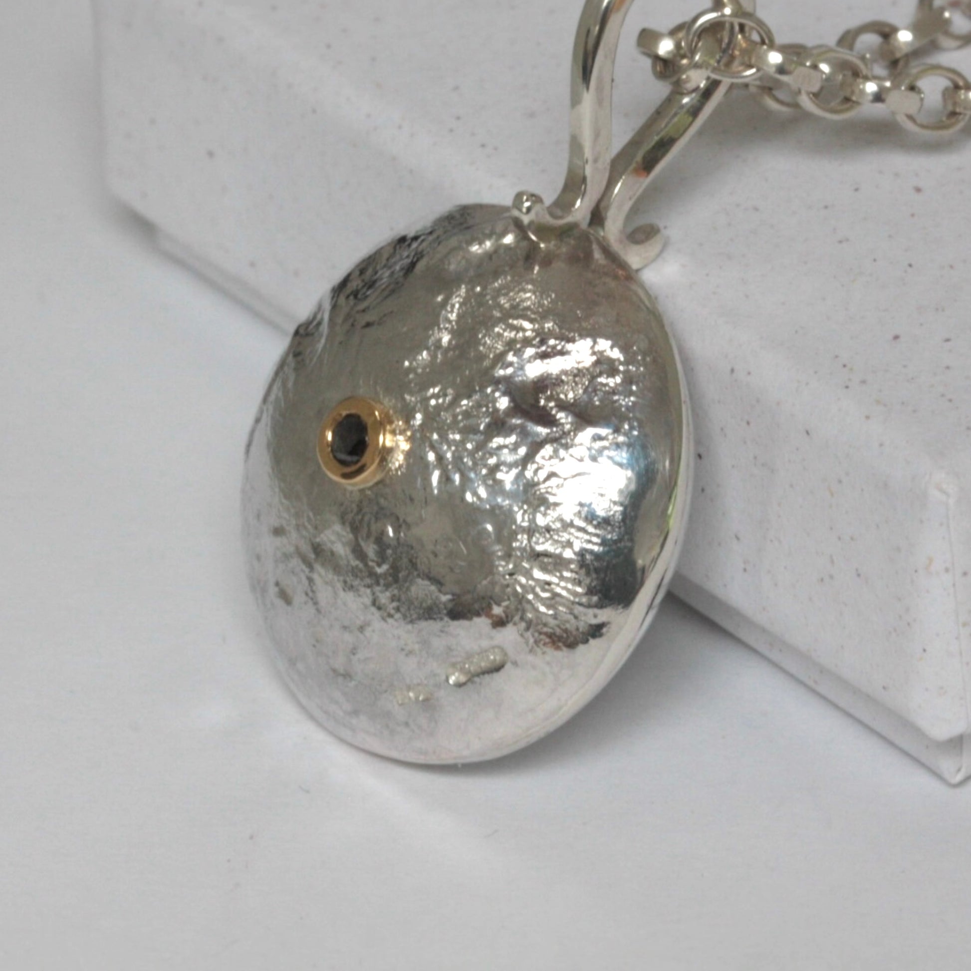 Reticulated silver necklace with salt and pepper diamond set in 18ct gold.