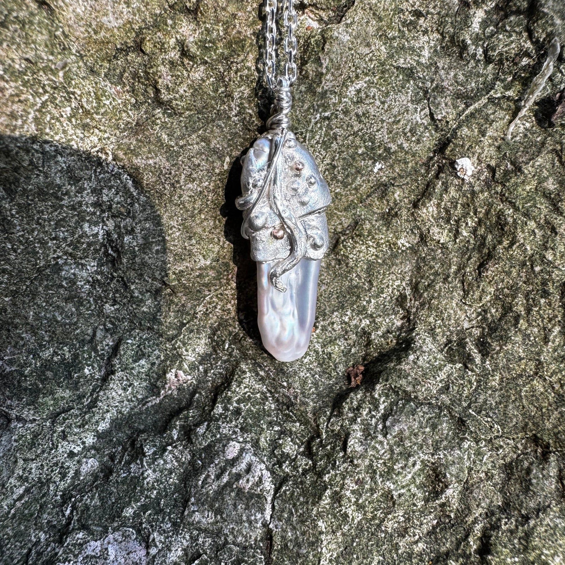 sterling silver and rose gold rustic style pendant featuring a keshi pearl.
