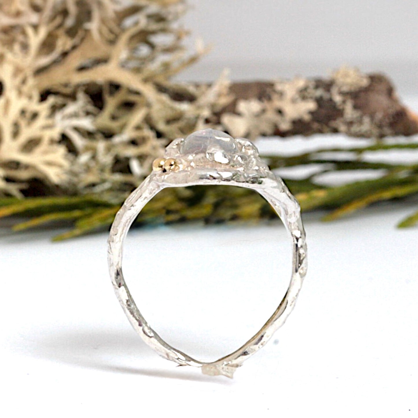 Handcrafted sterling silver ring with a 5mm round blue moonstone, two 18ct gold accent balls, and fused gold detailing, designed in a natural, organic shape.