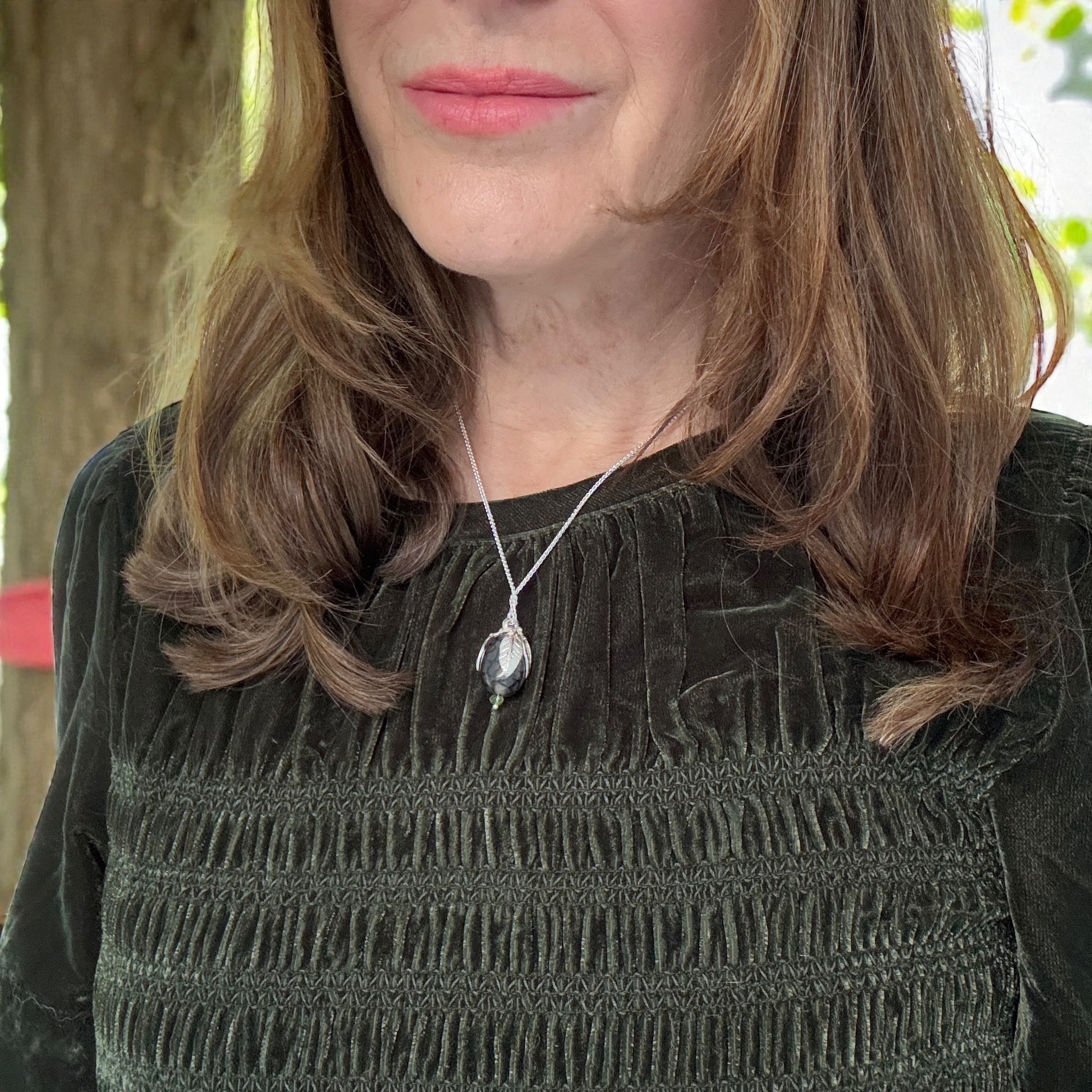 handmade sterling silver and gold leaf pendant with dragon vein agate and peridot gemstones.