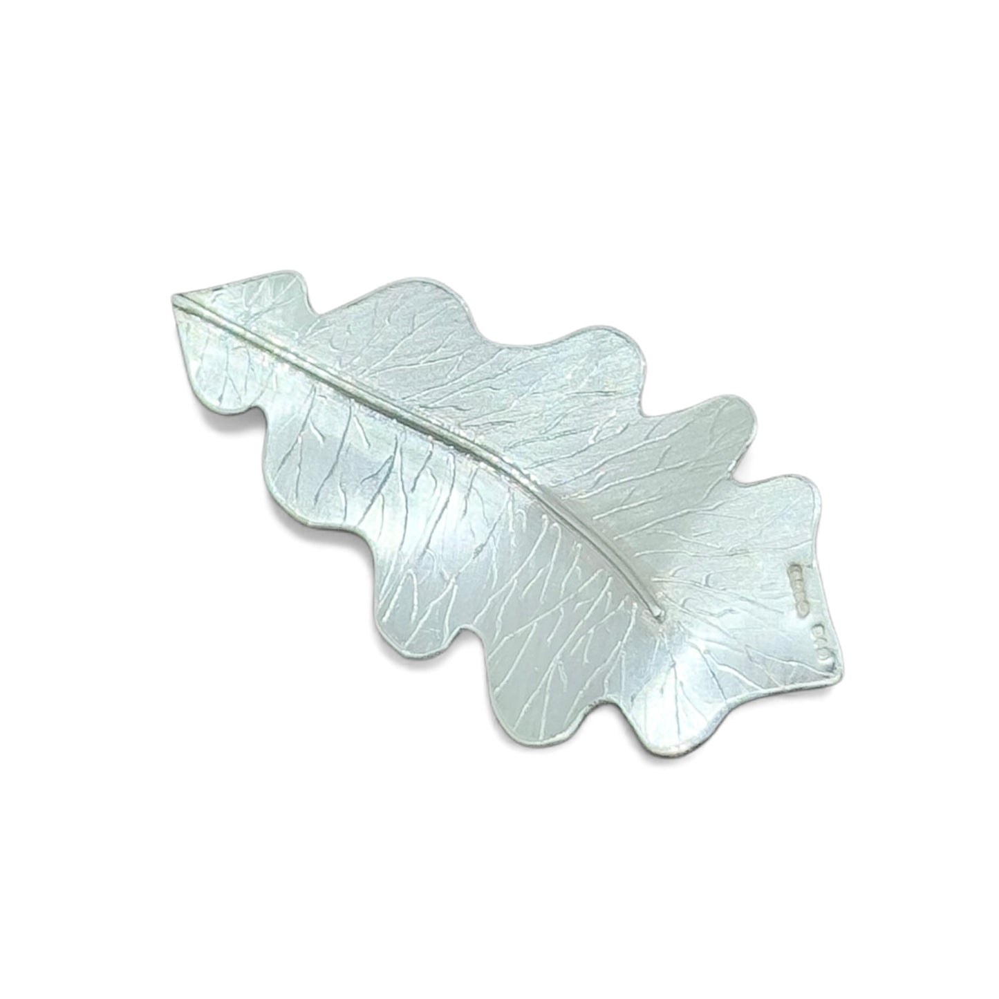 Silver leaf-shaped pendant on a white background