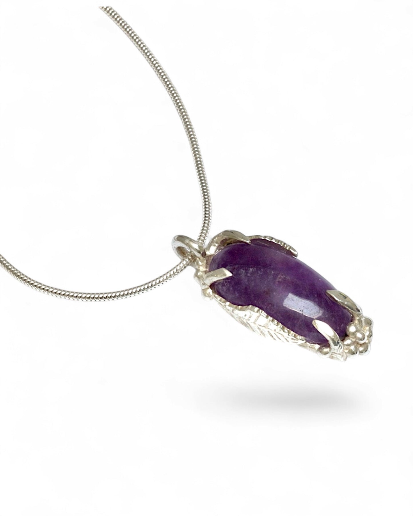 Hand carved sterling silver pendant with long oval cabochon amethyst, nature inspired twig and leaf setting on silver snake chain
