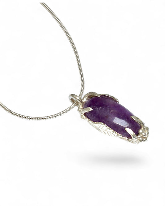 Hand carved sterling silver pendant with long oval cabochon amethyst, nature inspired twig and leaf setting on silver snake chain
