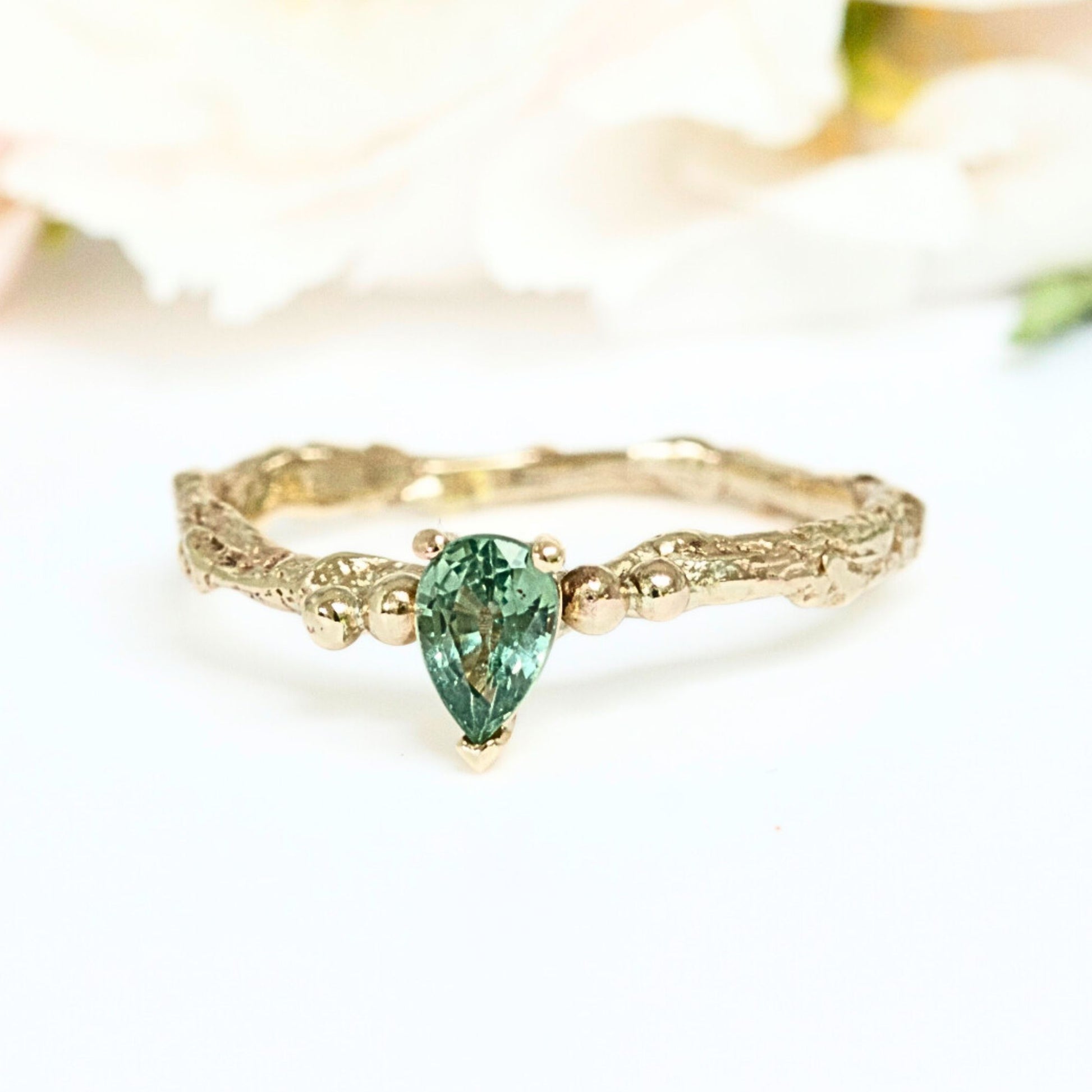 Pear shape green sapphire nature inspired twig engagement ring. Cast from a real twig in 9ct yellow gold and set with a teardrop green sapphire in a claw setting. Also can be ordered in white gold.