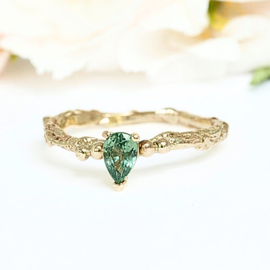 Pear shape green sapphire nature inspired twig engagement ring. Cast from a real twig in 9ct yellow gold and set with a teardrop green sapphire in a claw setting. Also can be ordered in white gold.