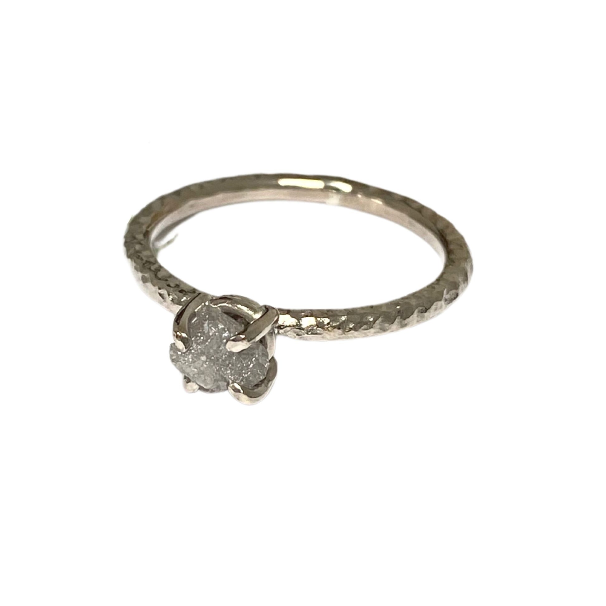 textured 18ct white gold engagement ring with a claw set natural rough uncut grey diamond.