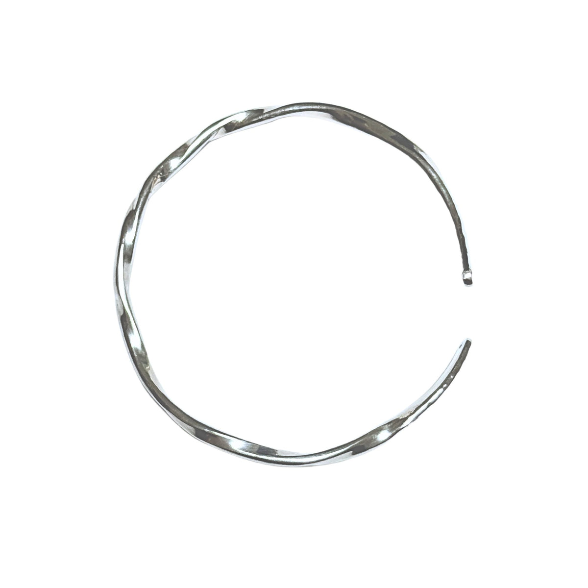 A polished silver-toned metal cuff bracelet with a twisted, organic wavy pattern, shown on a plain white background.