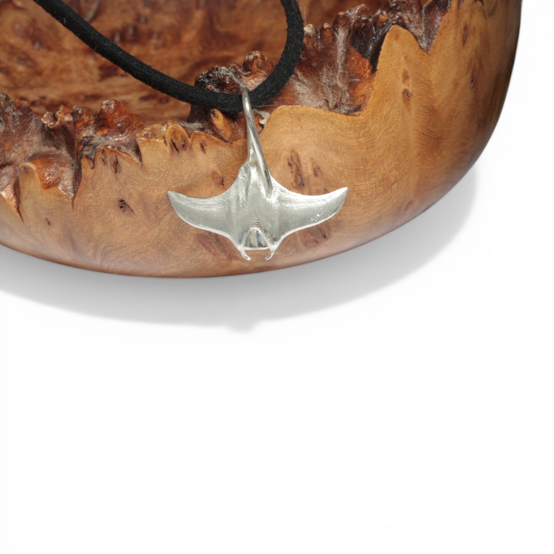Solid sterling silver manta ray pendant on a faux suede thong necklace.