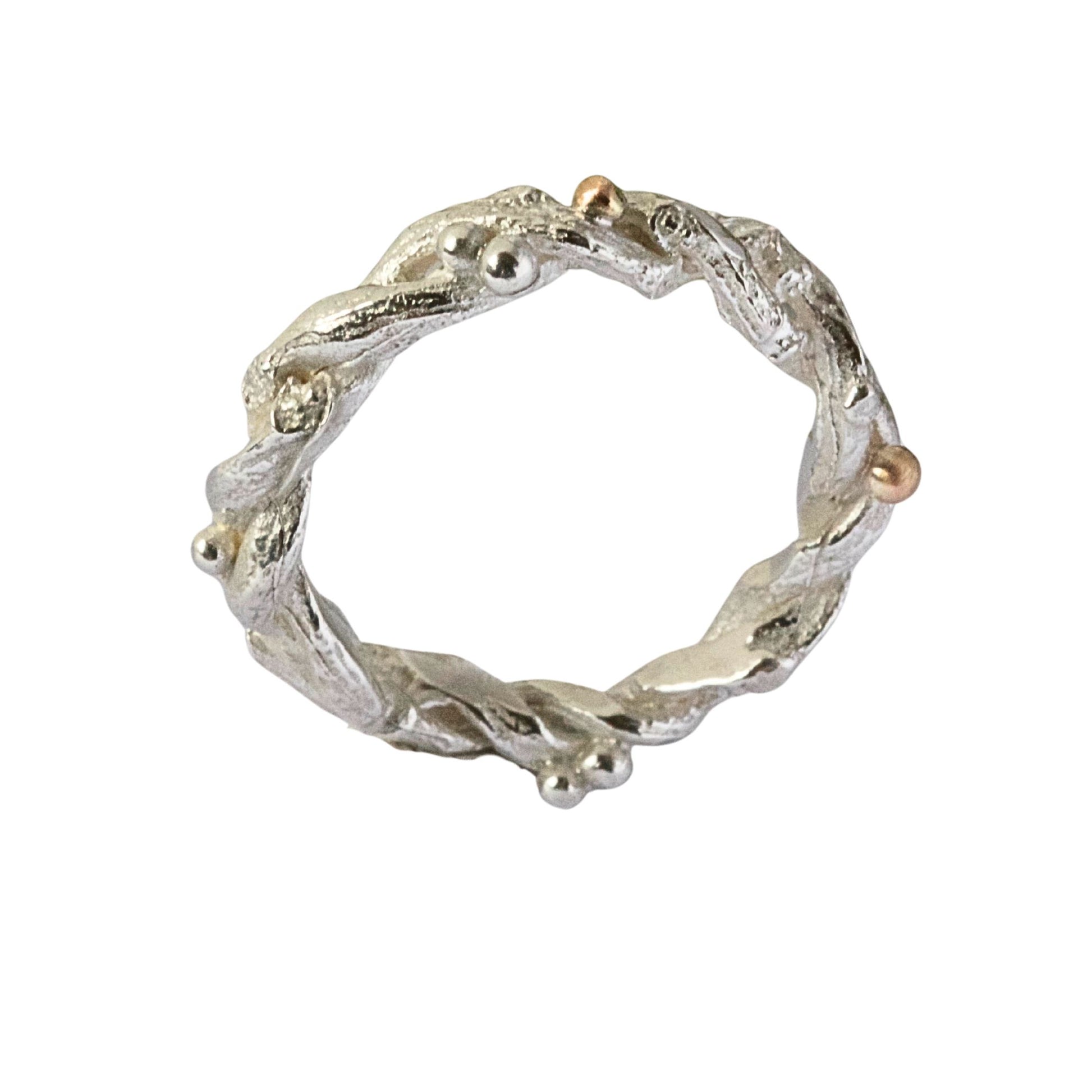 Entwined sterling silver twig ring with silver and 9ct gold berries, handcrafted woodland-inspired design.
