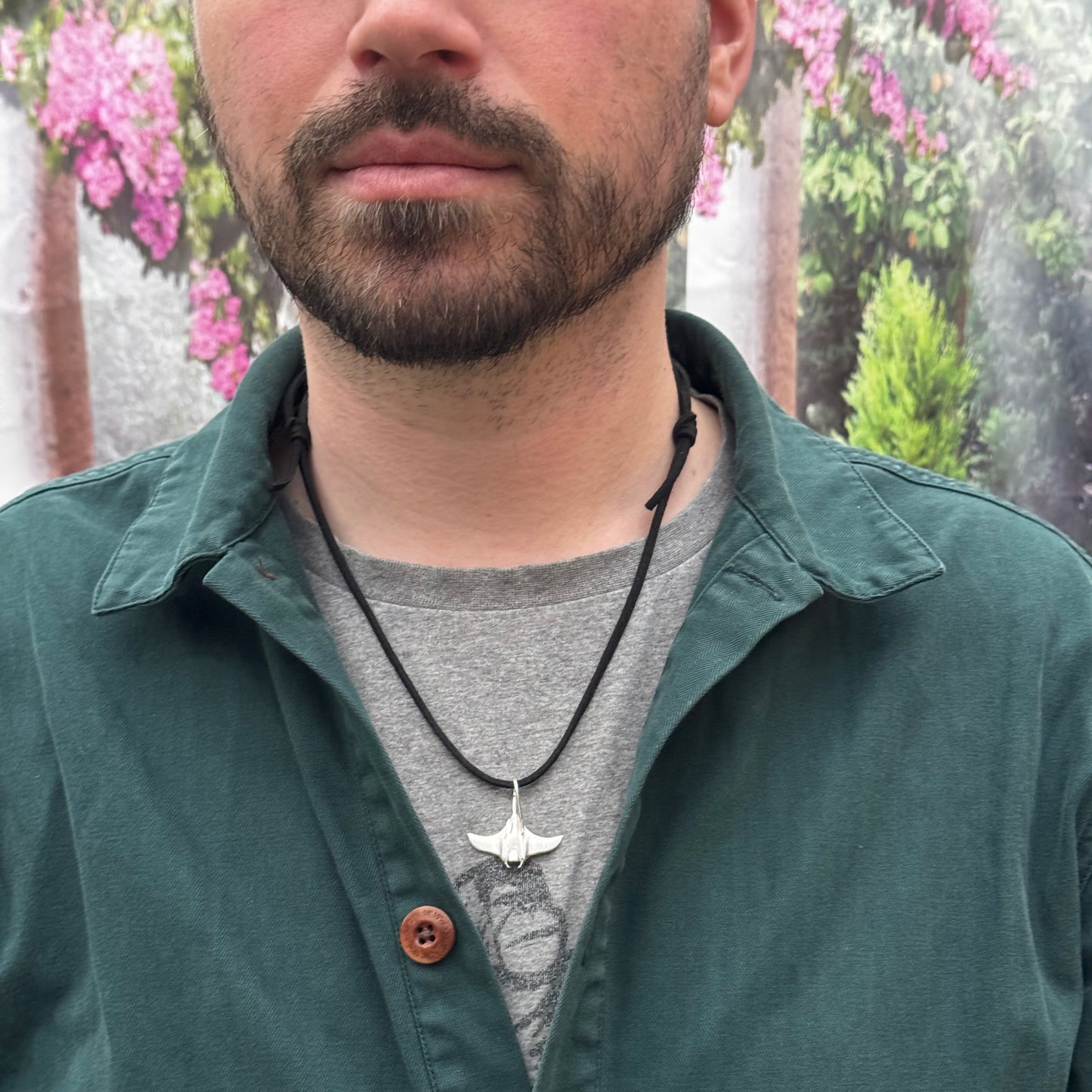 Solid sterling silver manta ray pendant on a faux suede thong necklace.