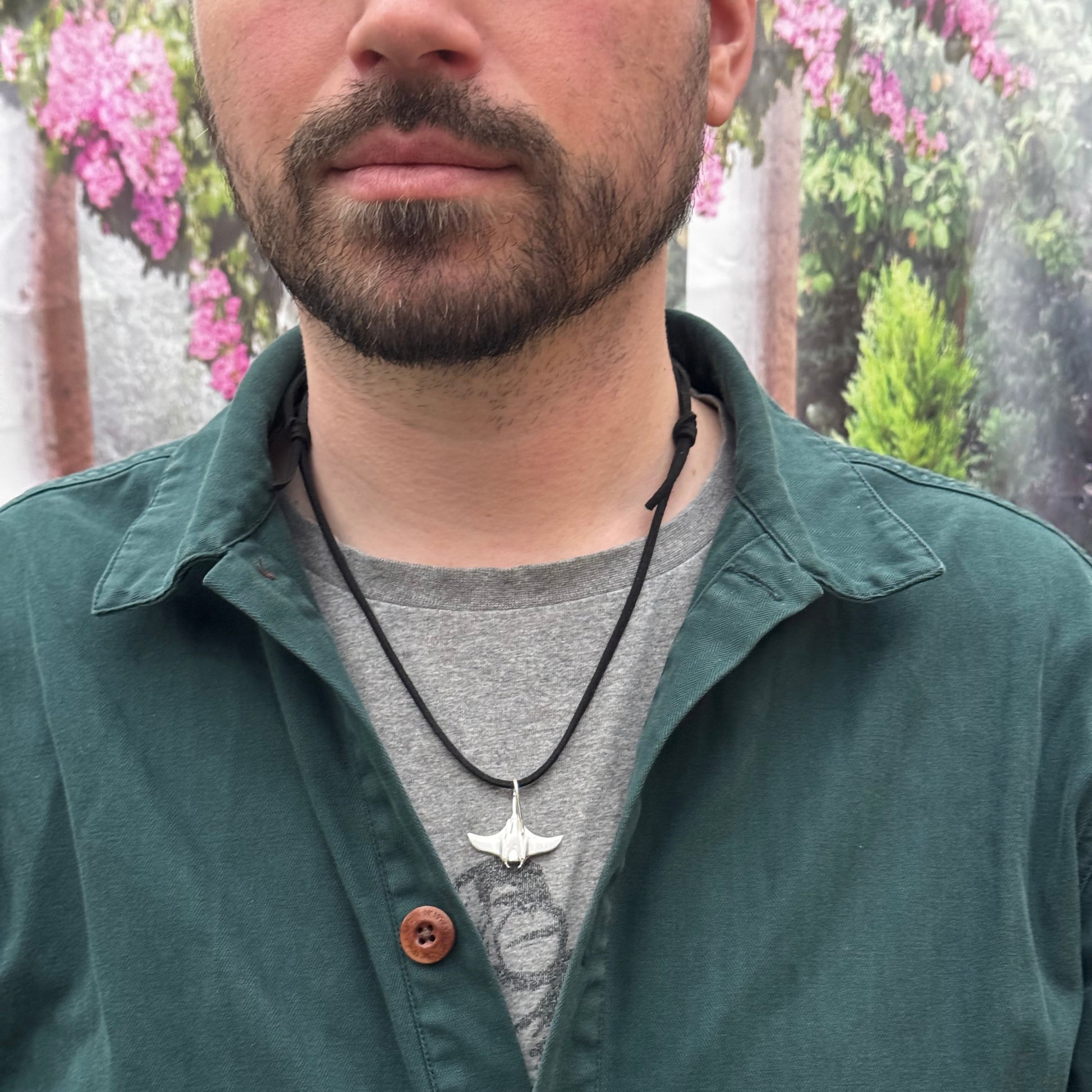 Solid sterling silver manta ray pendant on a faux suede thong necklace.