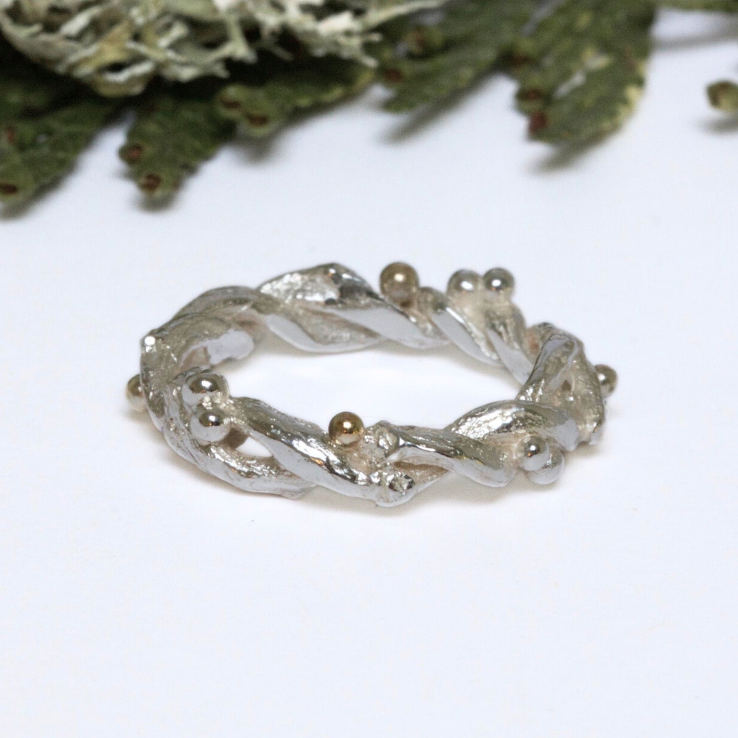 Entwined sterling silver twig ring with silver and 9ct gold berries, handcrafted woodland-inspired design.
