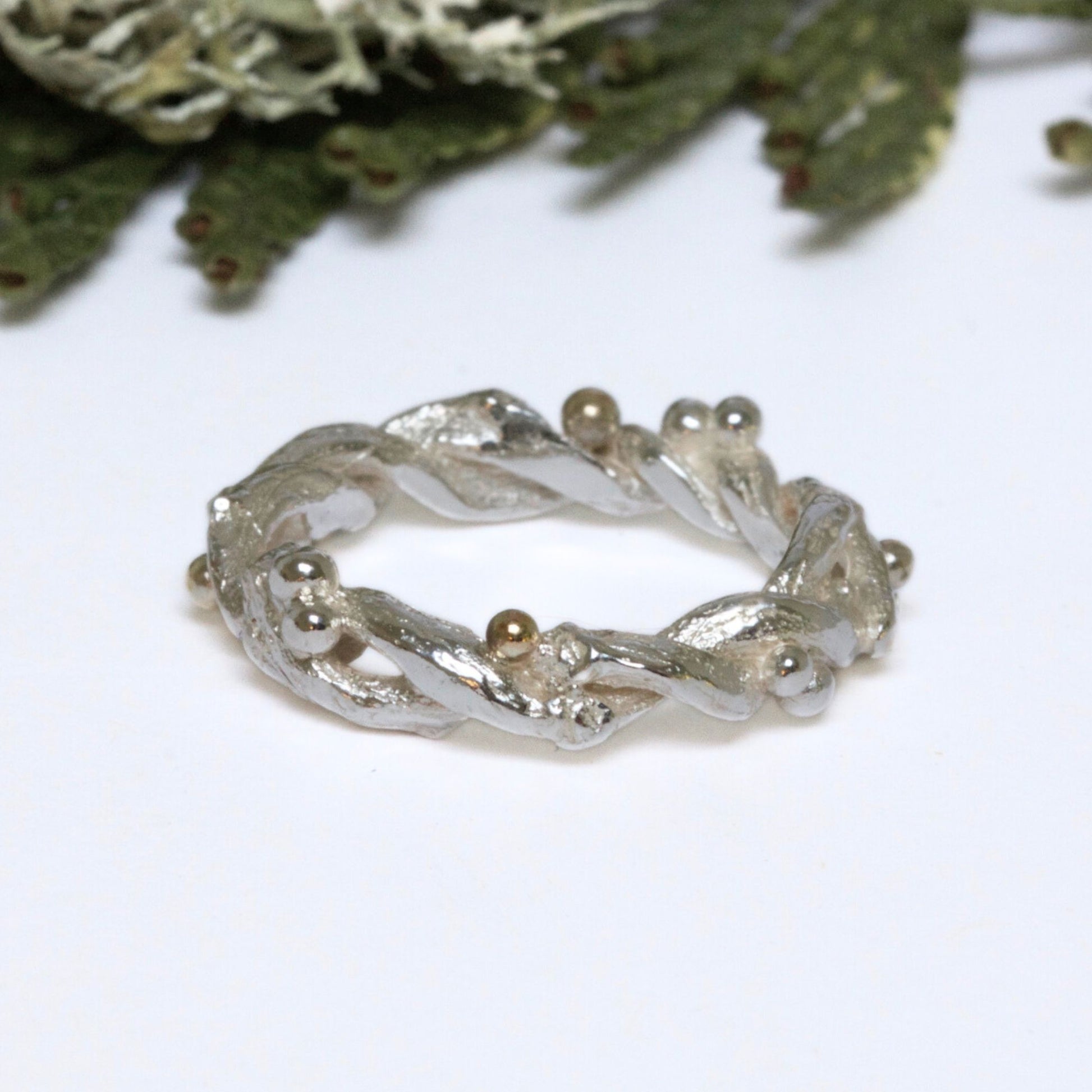 Entwined sterling silver twig ring with silver and 9ct gold berries, handcrafted woodland-inspired design.
