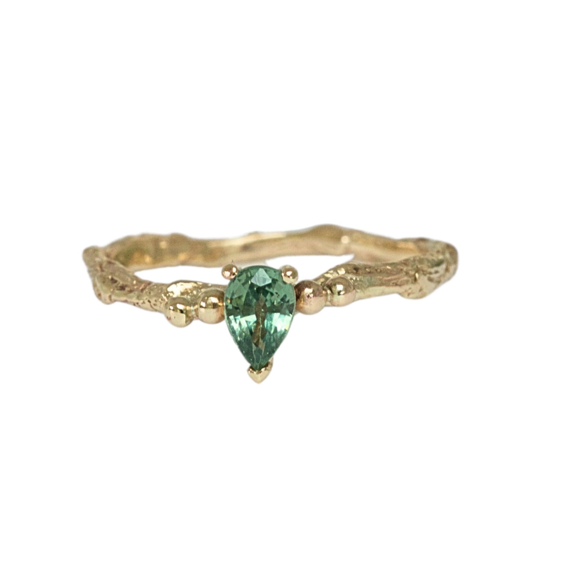 Pear shape green sapphire nature inspired twig engagement ring. Cast from a real twig in 9ct yellow gold and set with a teardrop green sapphire in a claw setting. Also can be ordered in white gold.