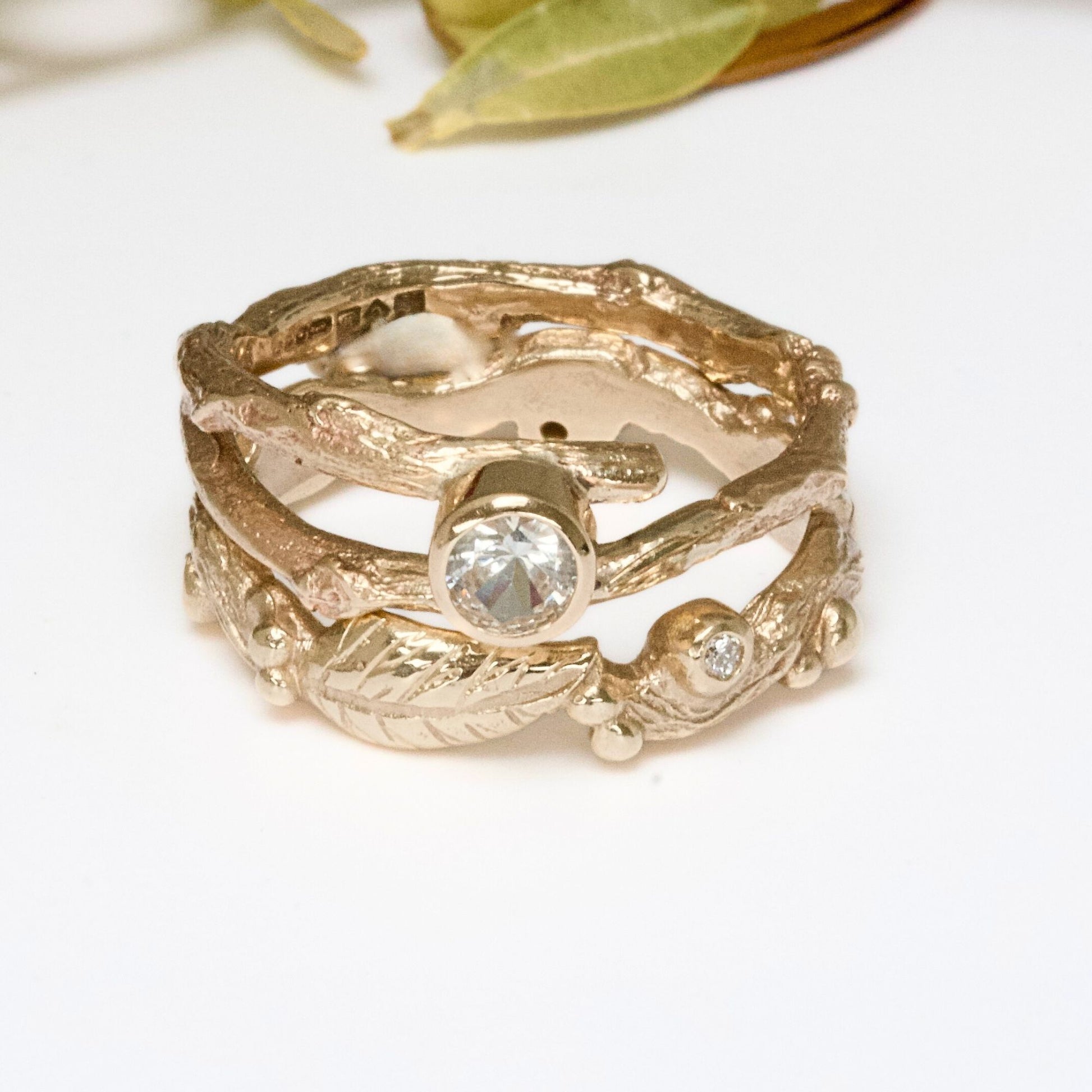 Nature inspired 9ct gold leaf ring, a carved woodland ring with twigs, leaves and berries and studded with champagne, white and salt and pepper natural diamonds. For nature lovers and woodland weddings.