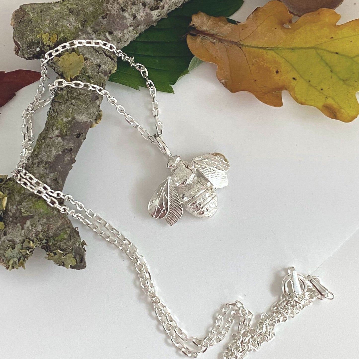 silver bee necklace with hand engraved wings