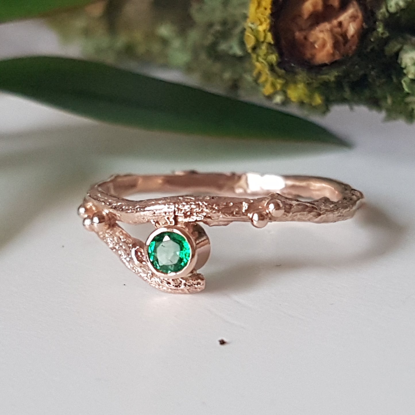 red gold and emerald twig engagement ring