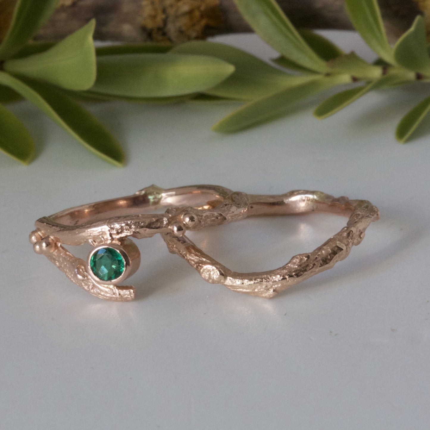 rose gold and emerald engagement and wedding ring set