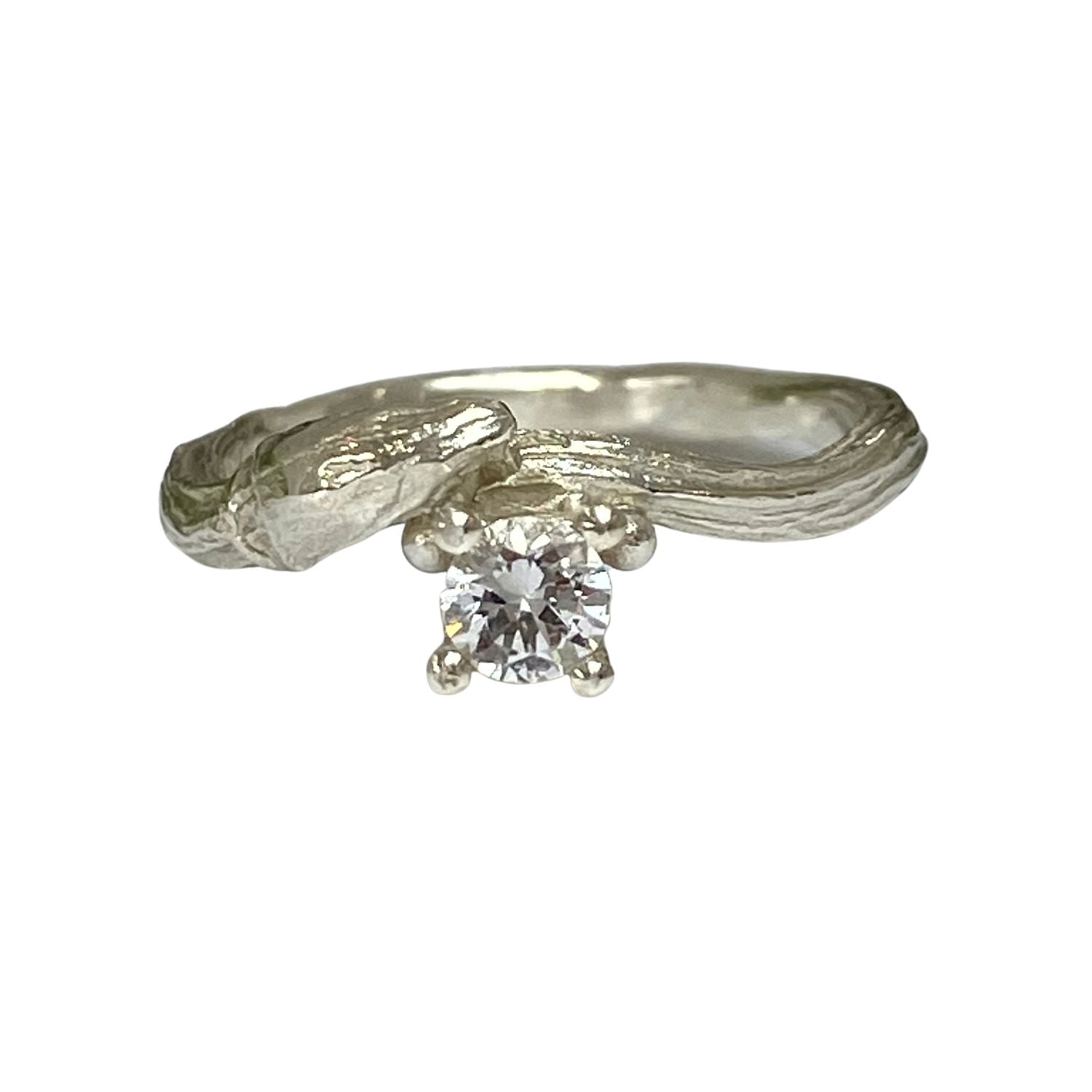 Cast from a real willow twig in solid 9ct gold,  showing the willow bud and bark details, this nature inspired twig ring is set with a brilliant cut natural sapphire. 