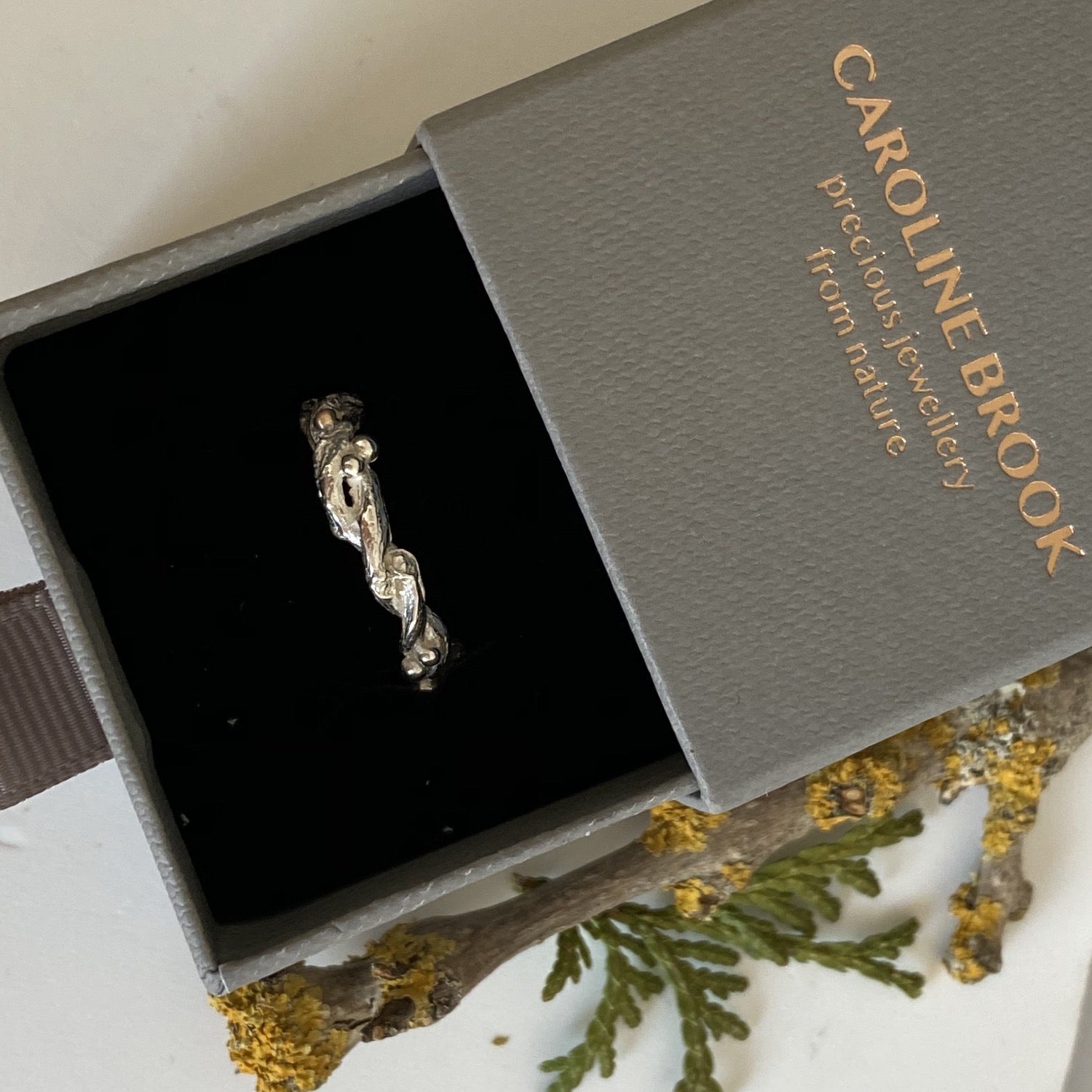Entwined sterling silver twig ring with silver and 9ct gold berries, handcrafted woodland-inspired design.
