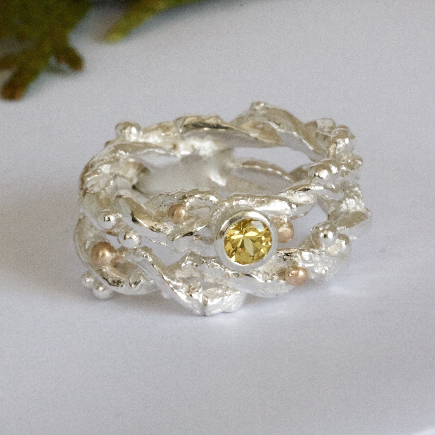 Entwined sterling silver twig ring with silver and 9ct gold berries, handcrafted woodland-inspired design.
