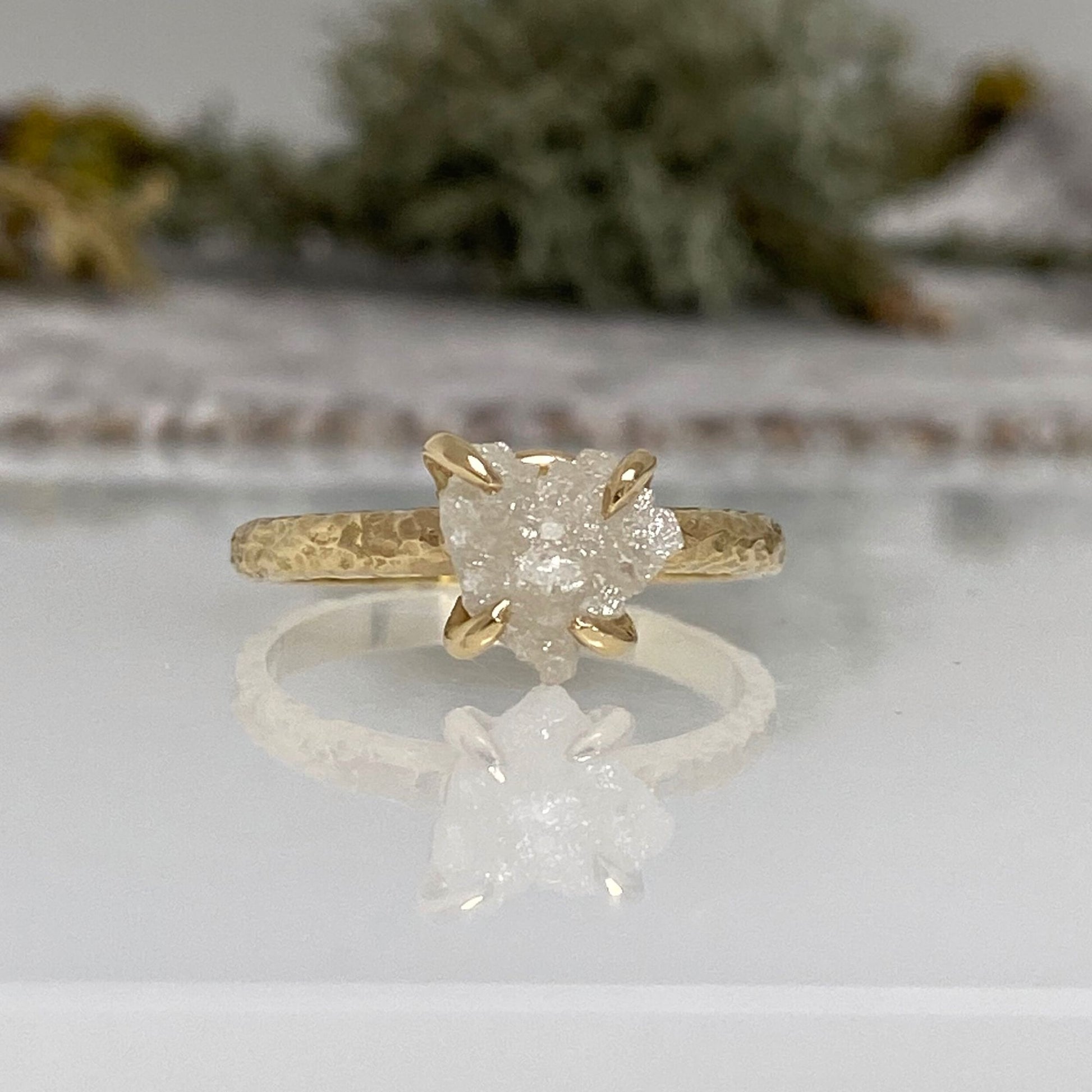 textured 18ct yellow gold engagement ring with a claw set natural raw uncut diamond.